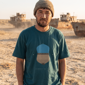 Uzbek man wearing green T-shirt at the Aral Sea